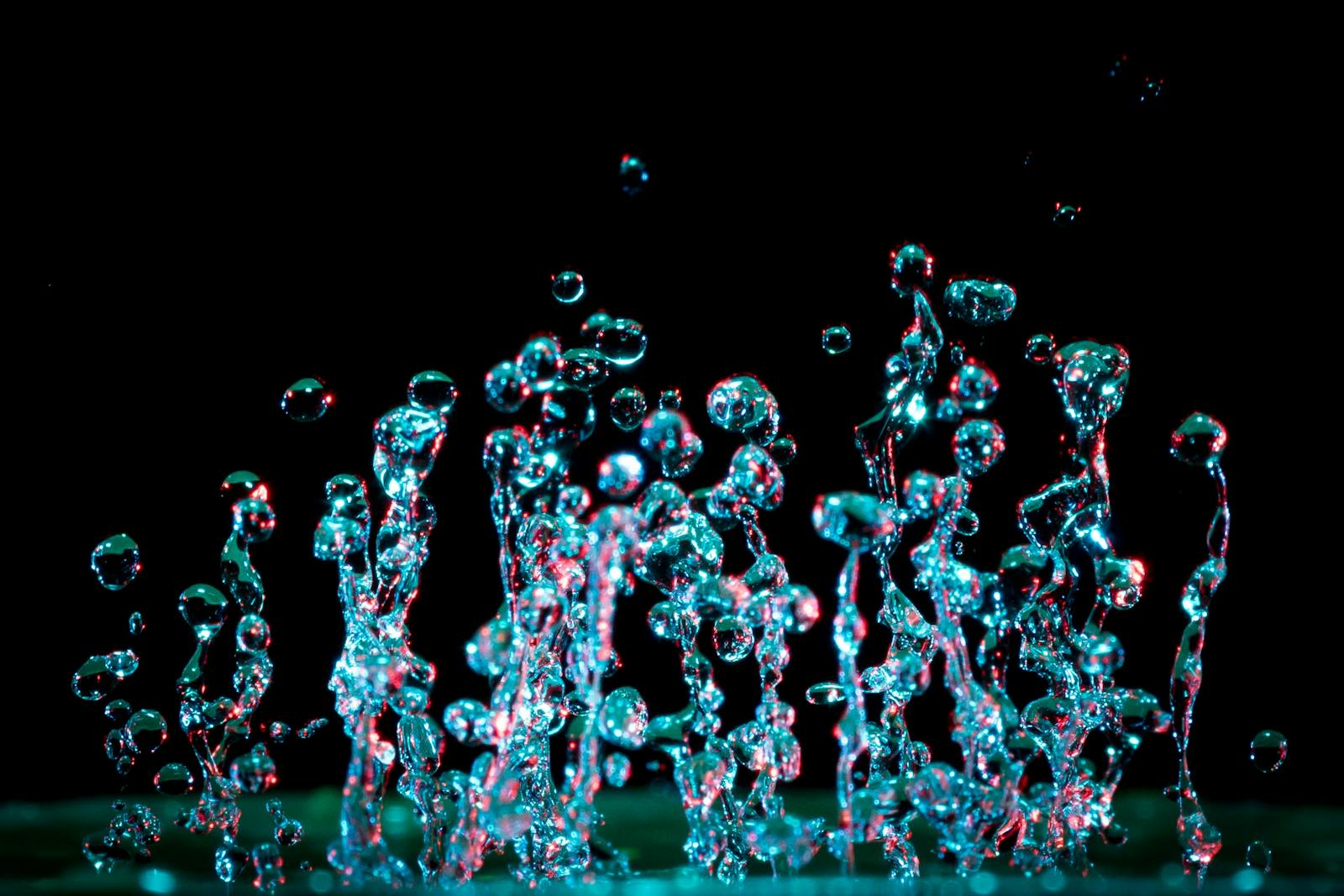 A striking close-up of vibrant water droplets capturing motion and abstract beauty. liquibase