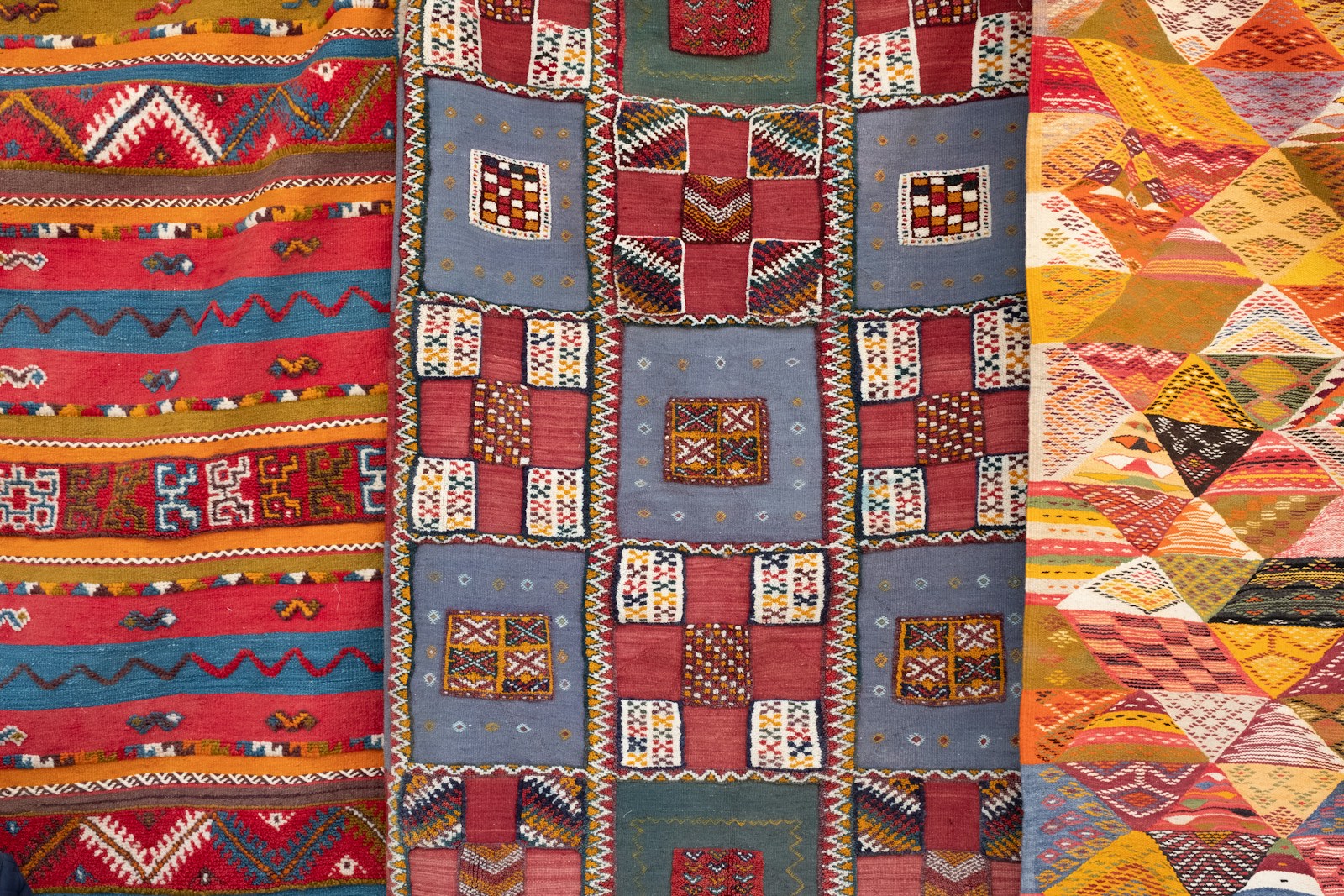 three assorted-color quilts,